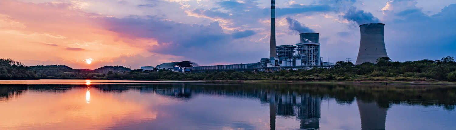 Nuclear power plant after sunset. Dusk landscape with big chimneys.